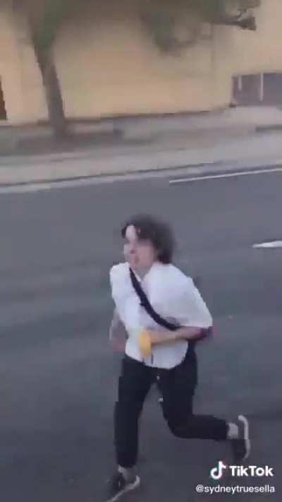 Girl tries to steal a Trump flag off of a pickup truck in Portland.