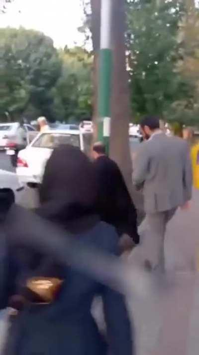 A mullah and his bodyguard are given a warm welcome by students they tried to stop protesting