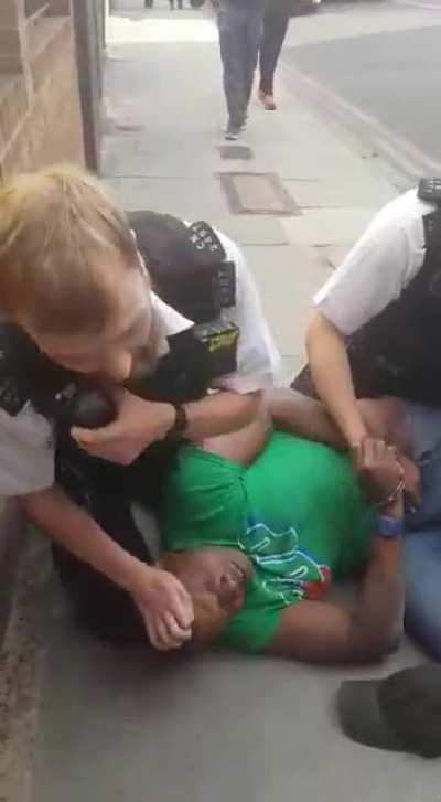 Officer with his knee on a black man's neck(UK)