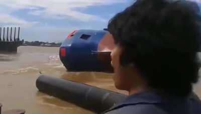 A ship being launched from dry dock ends up on its side - ca. 2018