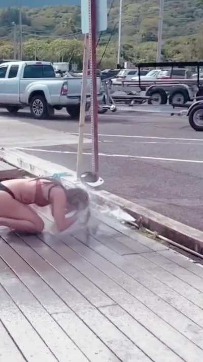 on her knees getting sprayed