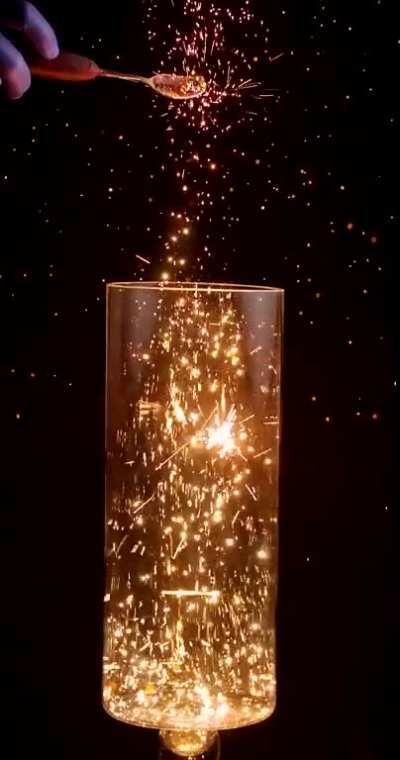 Pouring Burning Charcoal Dust into Oxygen in Slow Motion