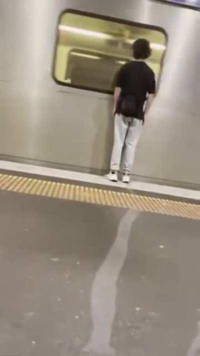 Trying to be funny by standing really close to a passing train.