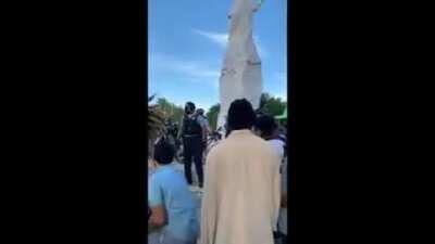 Rioters in Chicago throwing cans, rocks, and fireworks at police officers defending Columbus statue