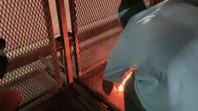 American Flag burned as a woman screams 