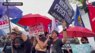 Police in Cebu, Philippines diverting the attention of anti-martial law and anti-marcos & duterte administration protesters by loudly performing a concert of their own (from Rappler)