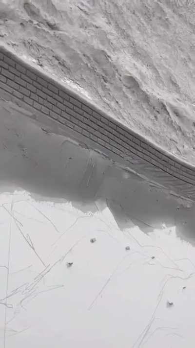 Artist using plaster to create a 3D painting of the Great Wall.