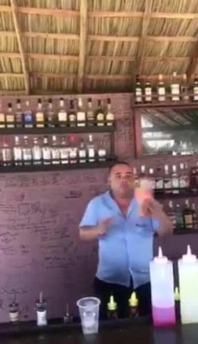 This bartender juggling with bottles