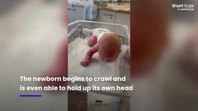 Baby girl defies expectations by attempting to crawl and support her own head just three days after birth.