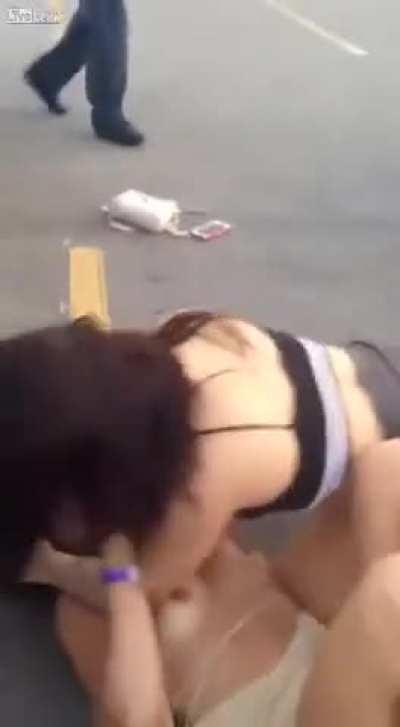 Half-naked women fight in parking lot