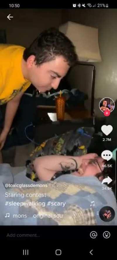 Guy stares at people while he is sleepwalking