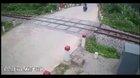 Idiot on motorcycle tries to race train