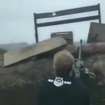 Ukraine soldiers, possibly Chechen fighters, fire a PKM at Russian militants while listening to hard bass