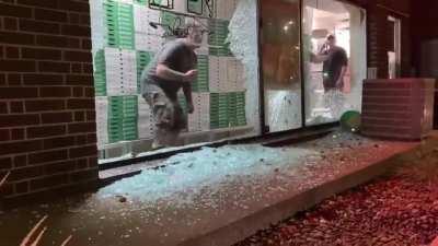 Looted store owner shouts at protestors