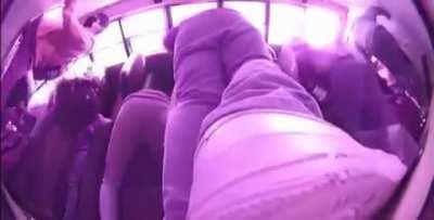 A car crashes into a school bus and flips it on it's side