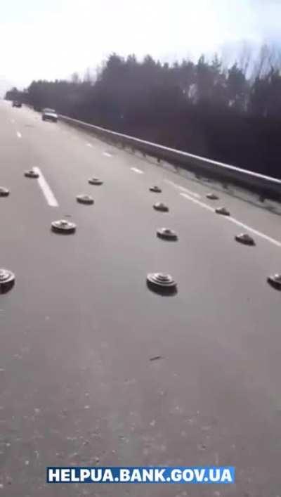 Ukrainians avoid mines left by the Russian army