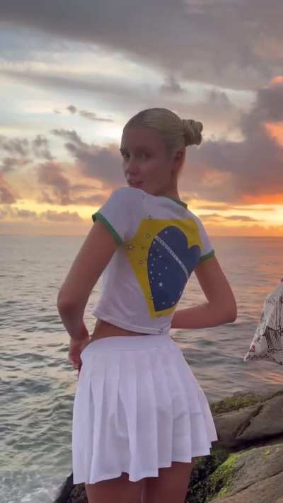 Polina Malinovskaya - Tiny White Mini Skirt and Mini Shorts with Brazil Colours T-Shirt at a Windy Rio Beach (IG Story Clip)