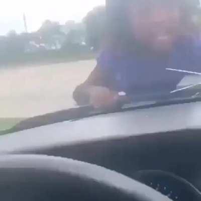 making a child ride on the windshield whilst driving