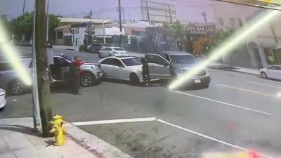 ICE hit & swarm a vehicle in LA immediately deploying tear gas and holding the occupants at gunpoint. The 2 men are US citizens per wife of one man