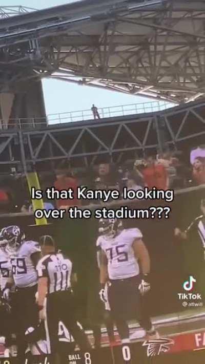 Kanye looking over stadium video