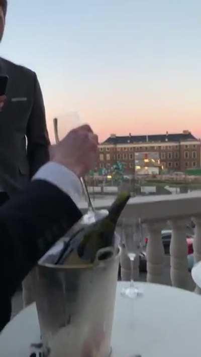 Sabering champagne with a glass