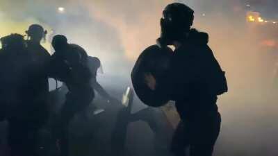 Portland Police charge at full speed.