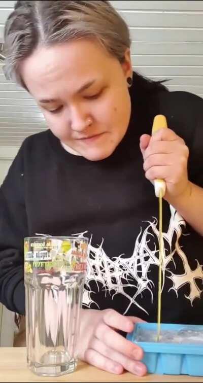 Adding ice to a glass