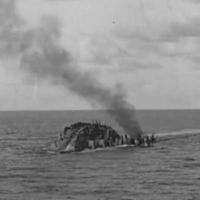 25 November 1941: Sailors jump from the hull of HMS Barham as she capsizes and her magazines explode.
