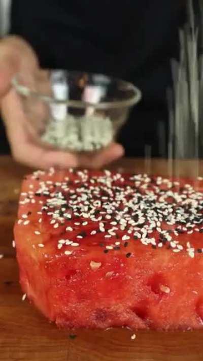 Seared watermelon tuna, served on a platter with vegetables.