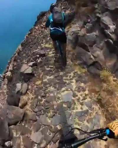 Mountain bikers riding down a cliff. I won't even walk there.