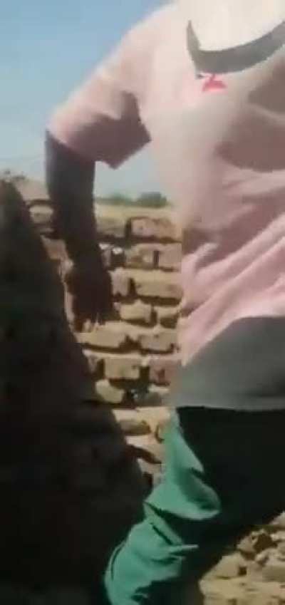 Sudanese combatants allied to Sudanese Army shoot a retreating RSF fighter fleeing from Tekina town after SAF took control