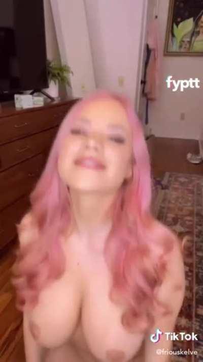 Pink haired girl makes her firm big Tik tits bounce by sitting up and down