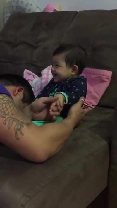 Baby girl pretends to cry as dad tries to clip her nails