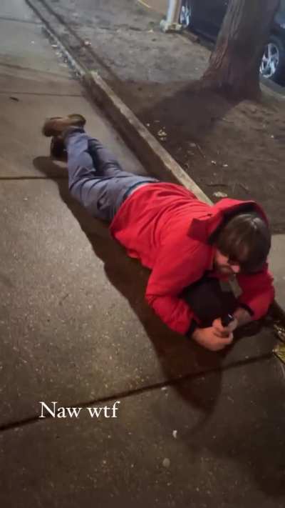 Man laying on sidewalk says that he needs the police or a firefighter to help him