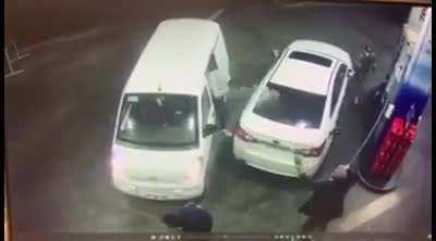 Trying to rob someone who's filling his car with gasoline.