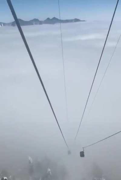 Riding a lift that takes you above the clouds