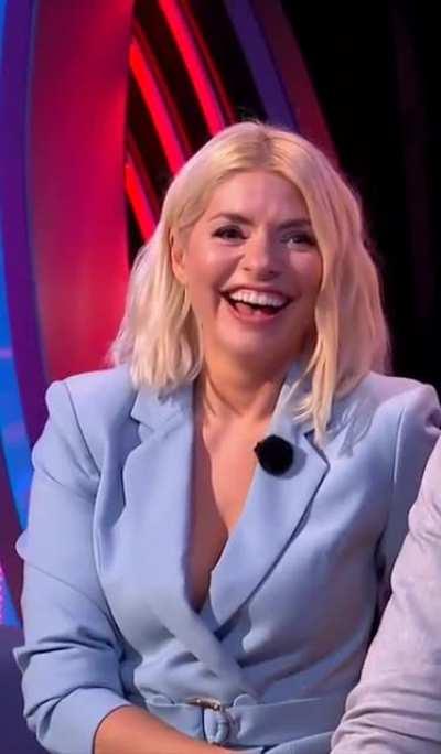 Holly presenting The Games in a light blue suit