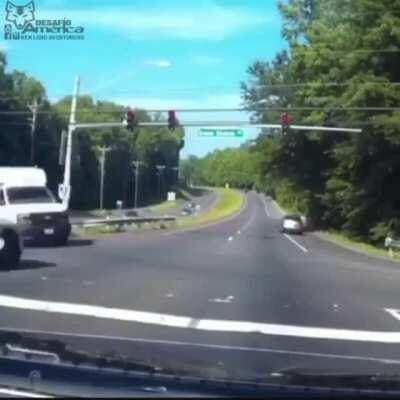 Biker runs a red light.