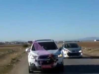 Guy shoots a fireworks on a wedding car, ends up exploding in his car.