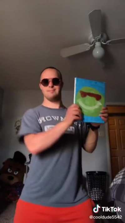 Stefan dancing whilst showing off his art and his license plate