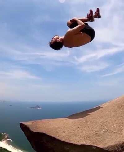 Guy almost falls off a cliff
