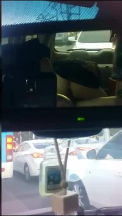 in the backseat of a taxi during a traffic jam