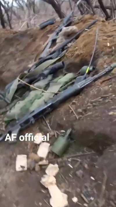 Ukrainian soldier films his fighting position, with some interesting clutter lying about.