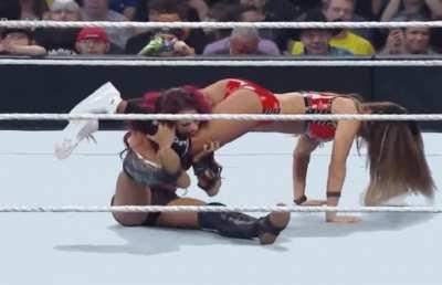 Nikki Bella doing push ups while dominating Sasha Banks
