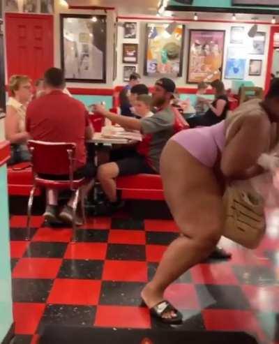 Lady twerks in front of a family minding their own business at a restaurant