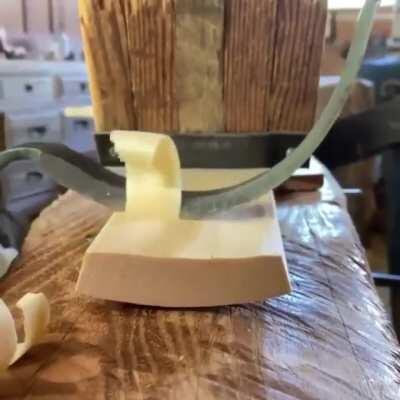 Carving wood with a drawknife