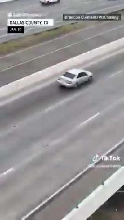 Texans driving over an icy bridge