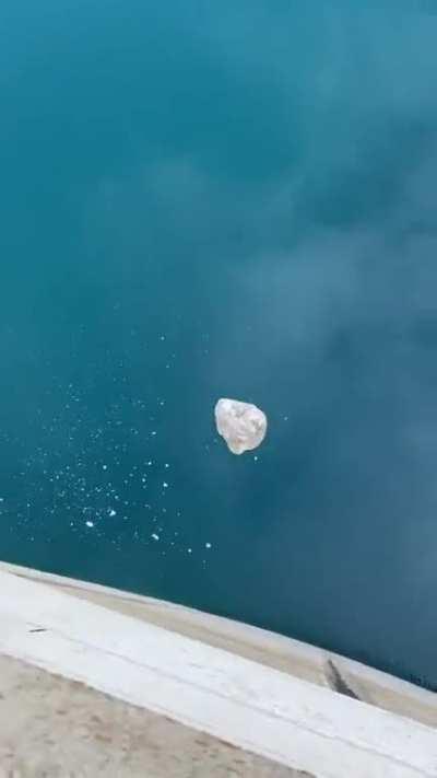 Dropping a big rock from a dam