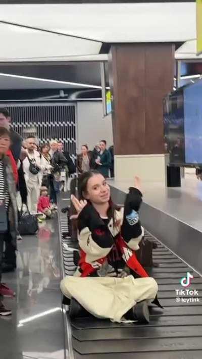 Sitting on luggage band while people waiting for their baggage. 