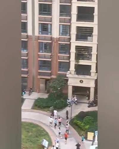 kid dangling with his head stuck in the railings saved
